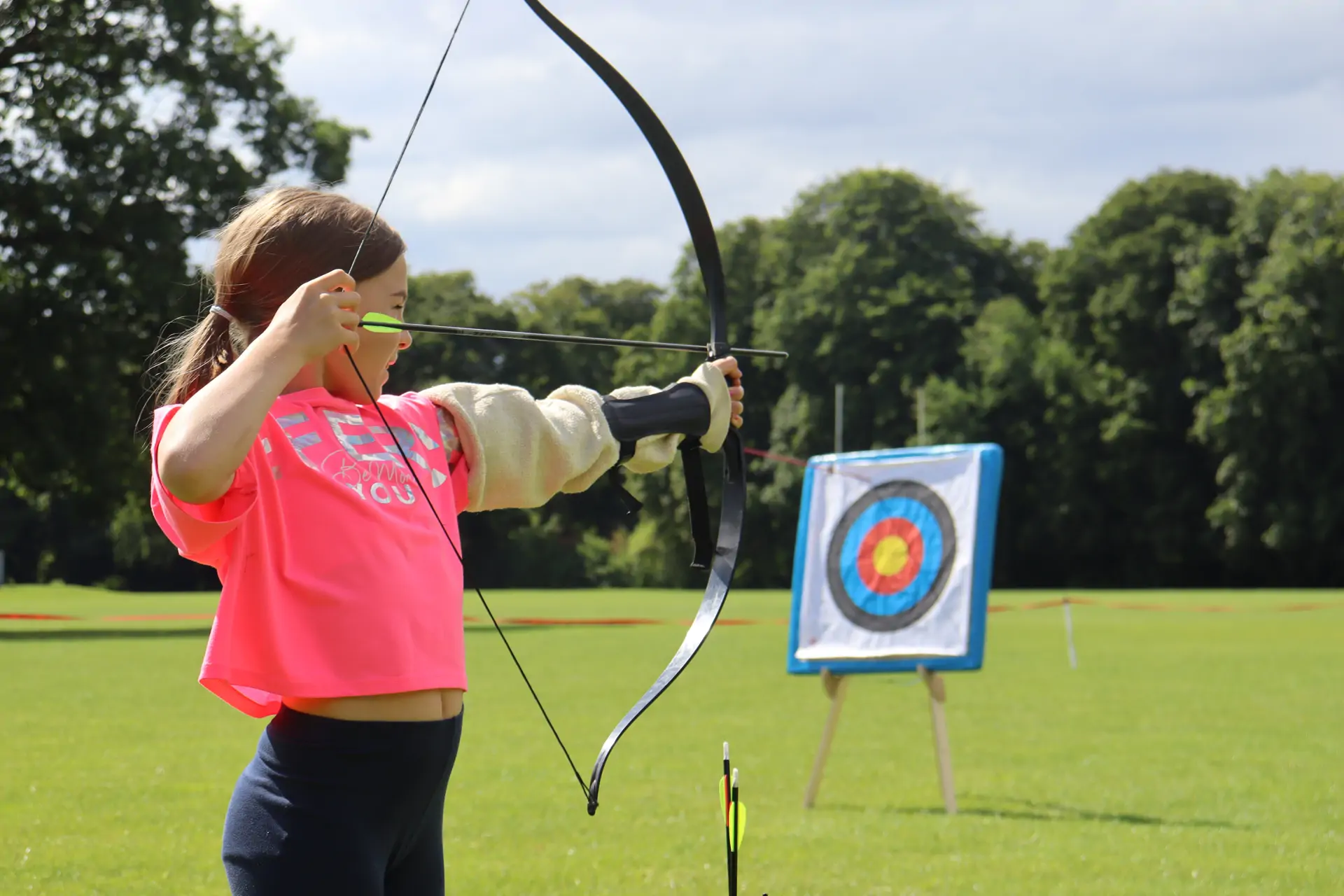 Barracudas camp girl doing archery.jpg