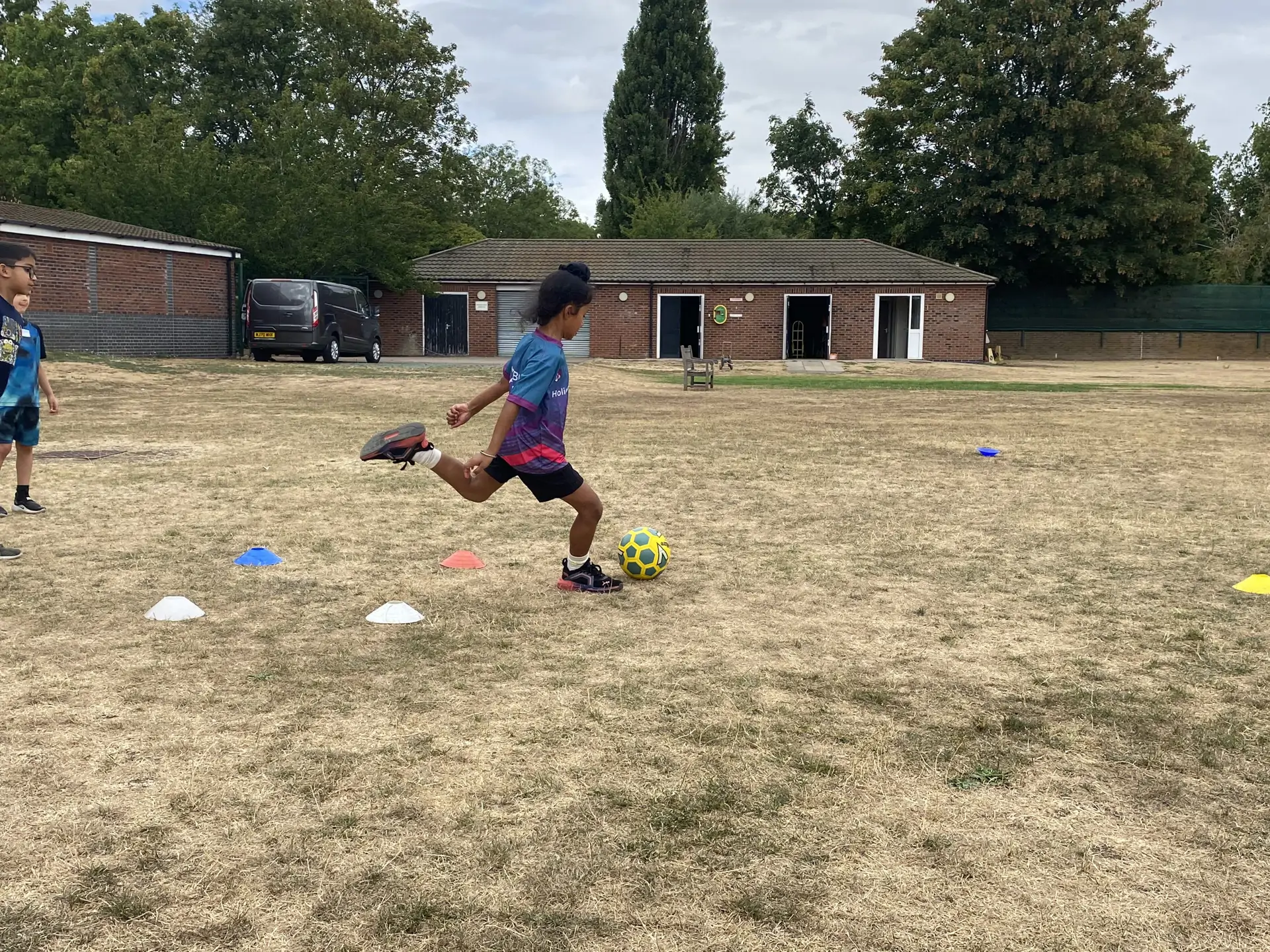 Girl showing football skills at Barracudas Bedford camp.jpg