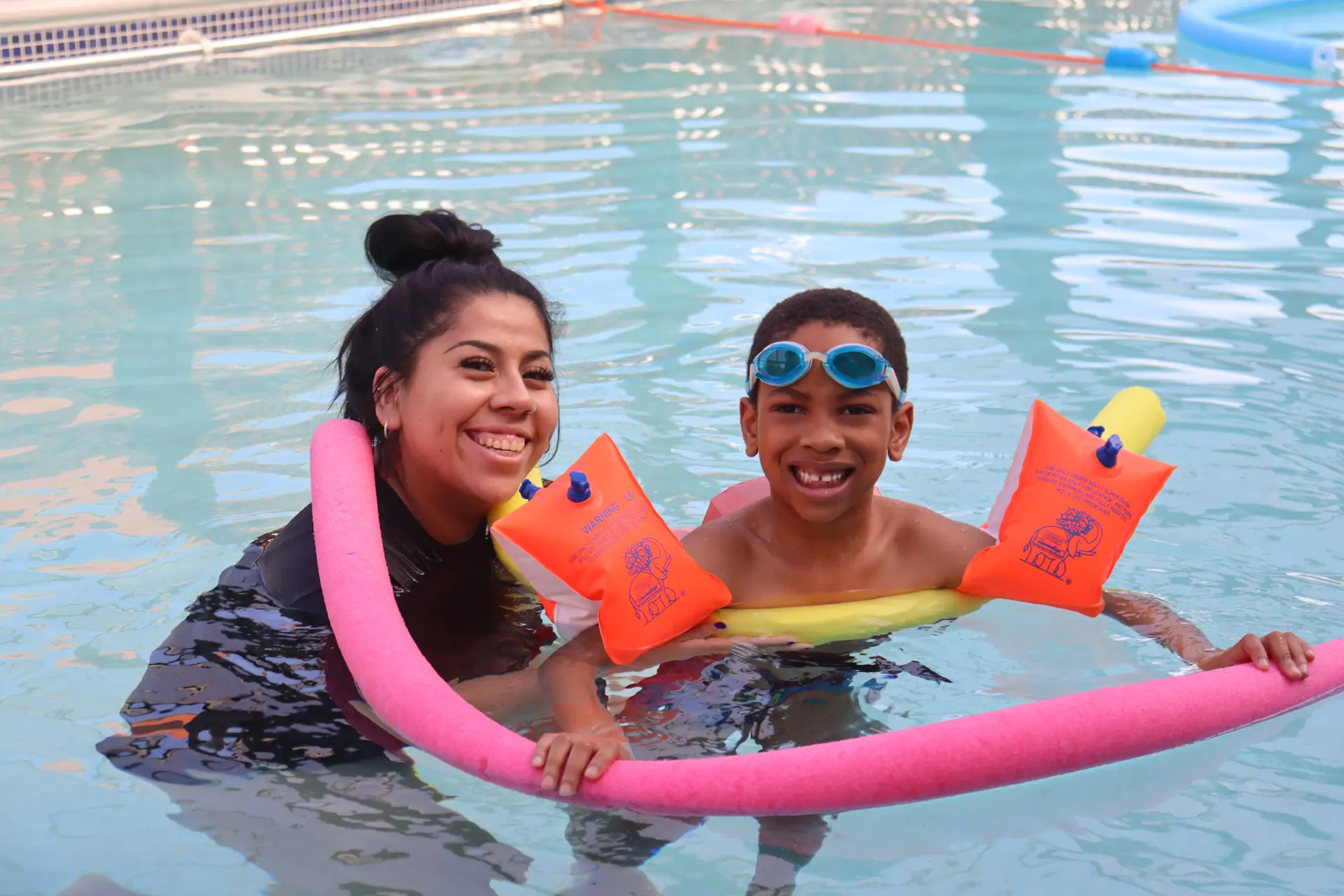 Barracudas camp swim session with staff, armbands and noodle.jpg