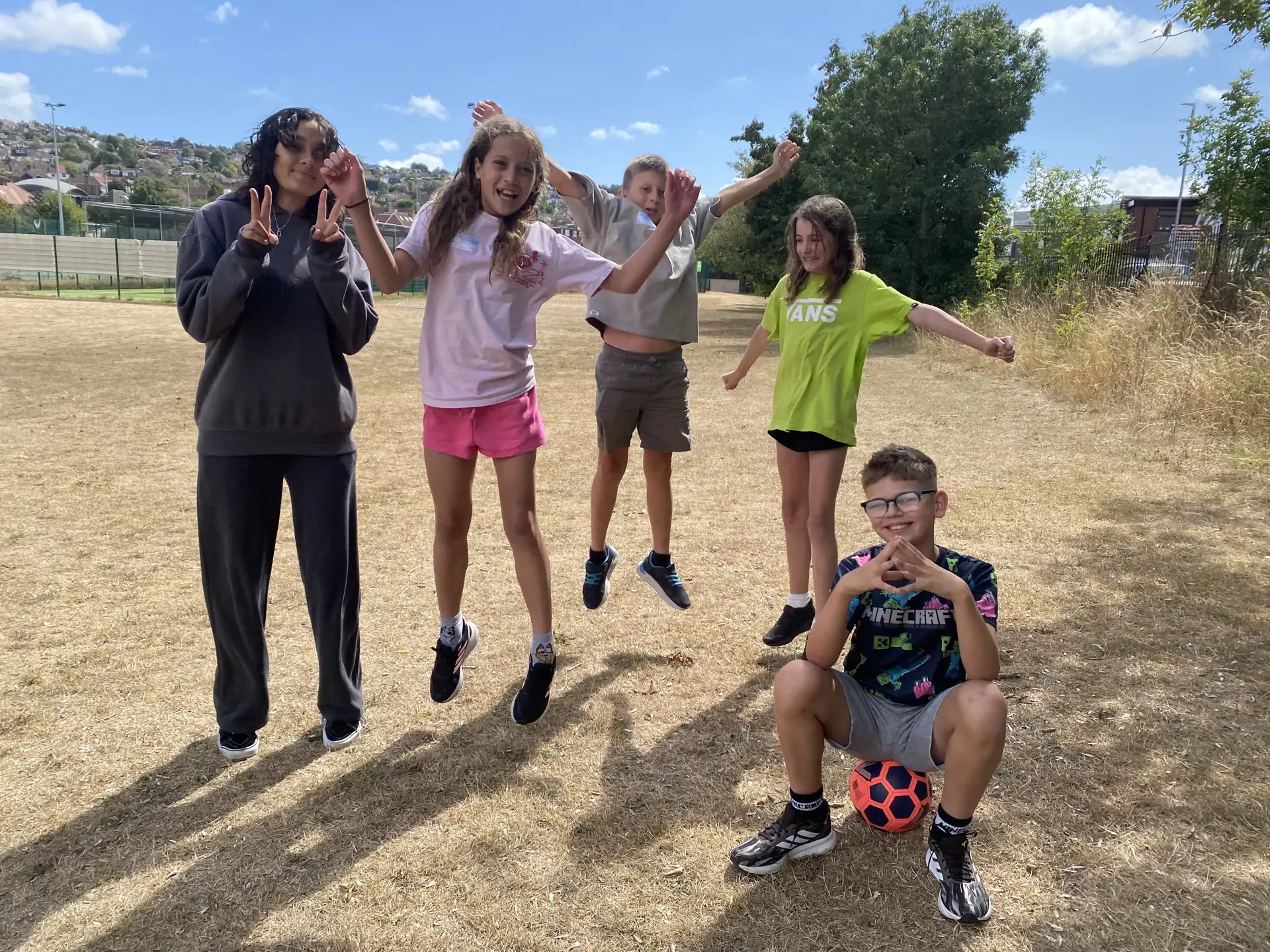 Smiling group on the field at Brighton Barracudas camp.jpg