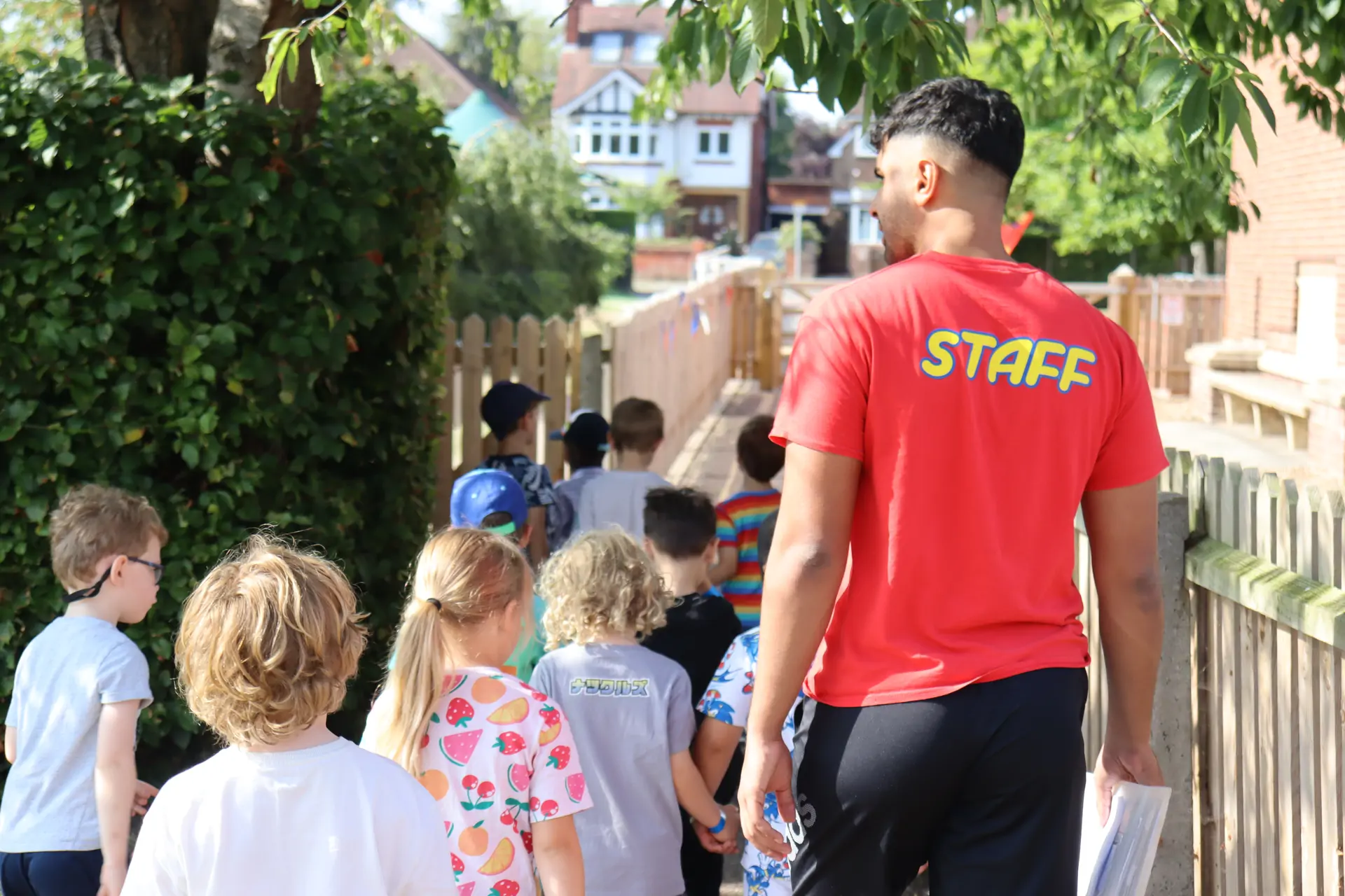 Red shirt walking a group.jpg